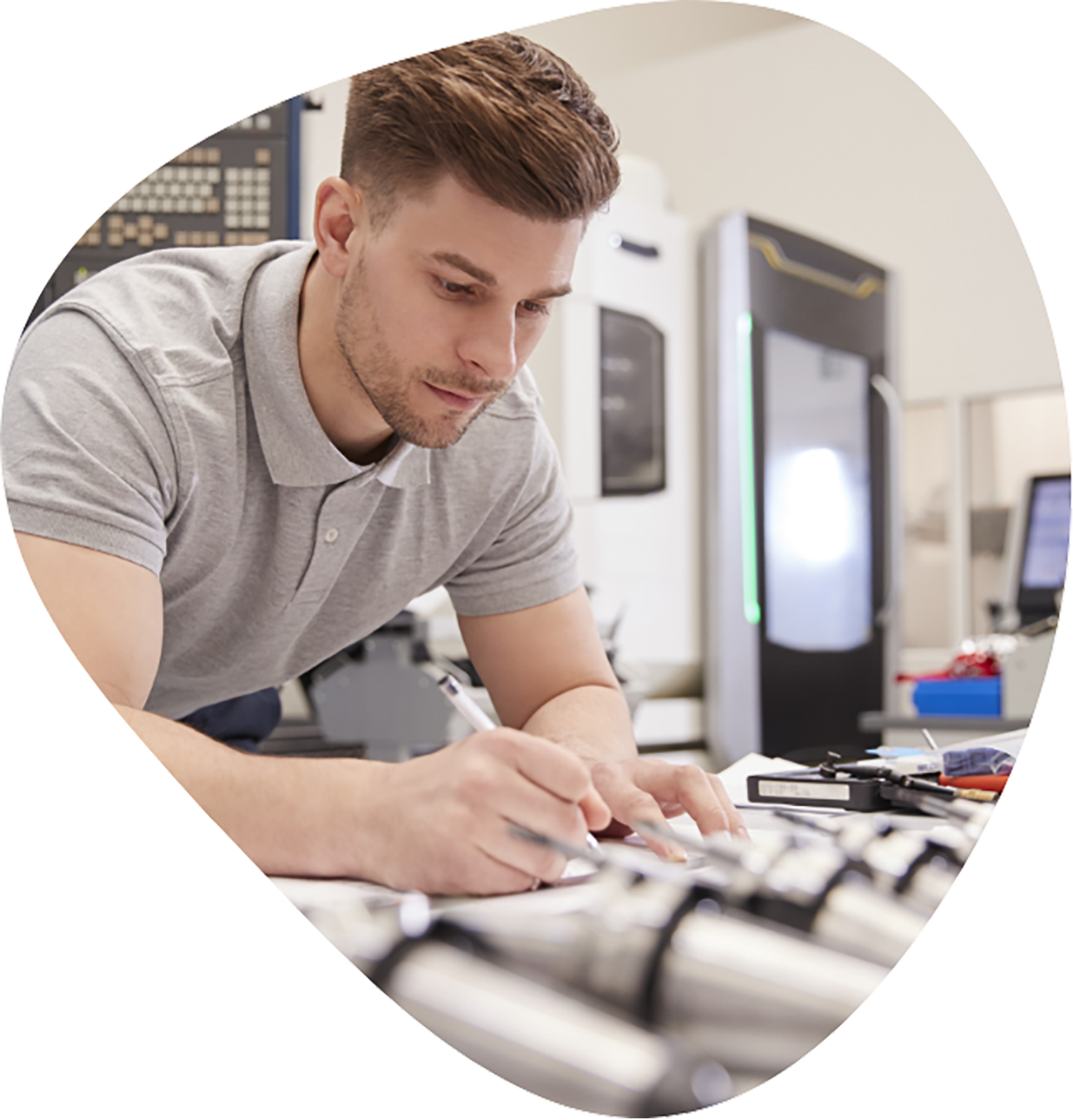 Male engineer measuring CAD drawings in factory