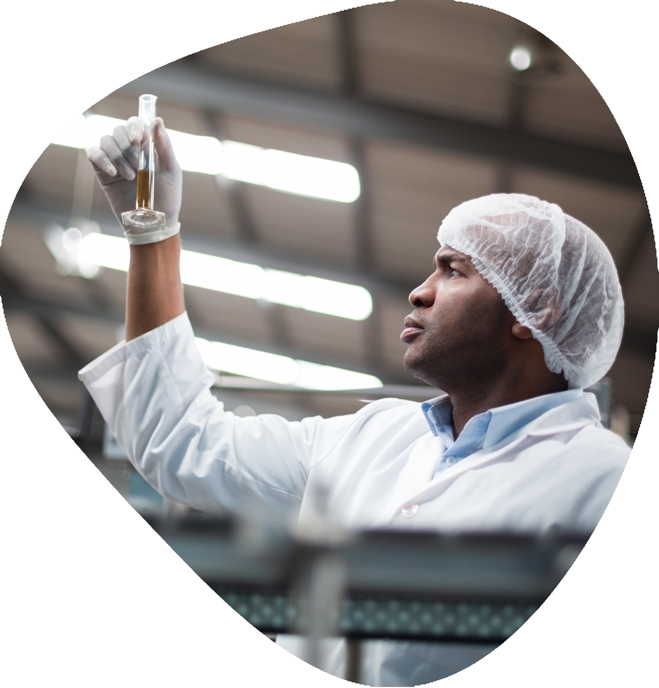 Factory engineers checking a sample of drink